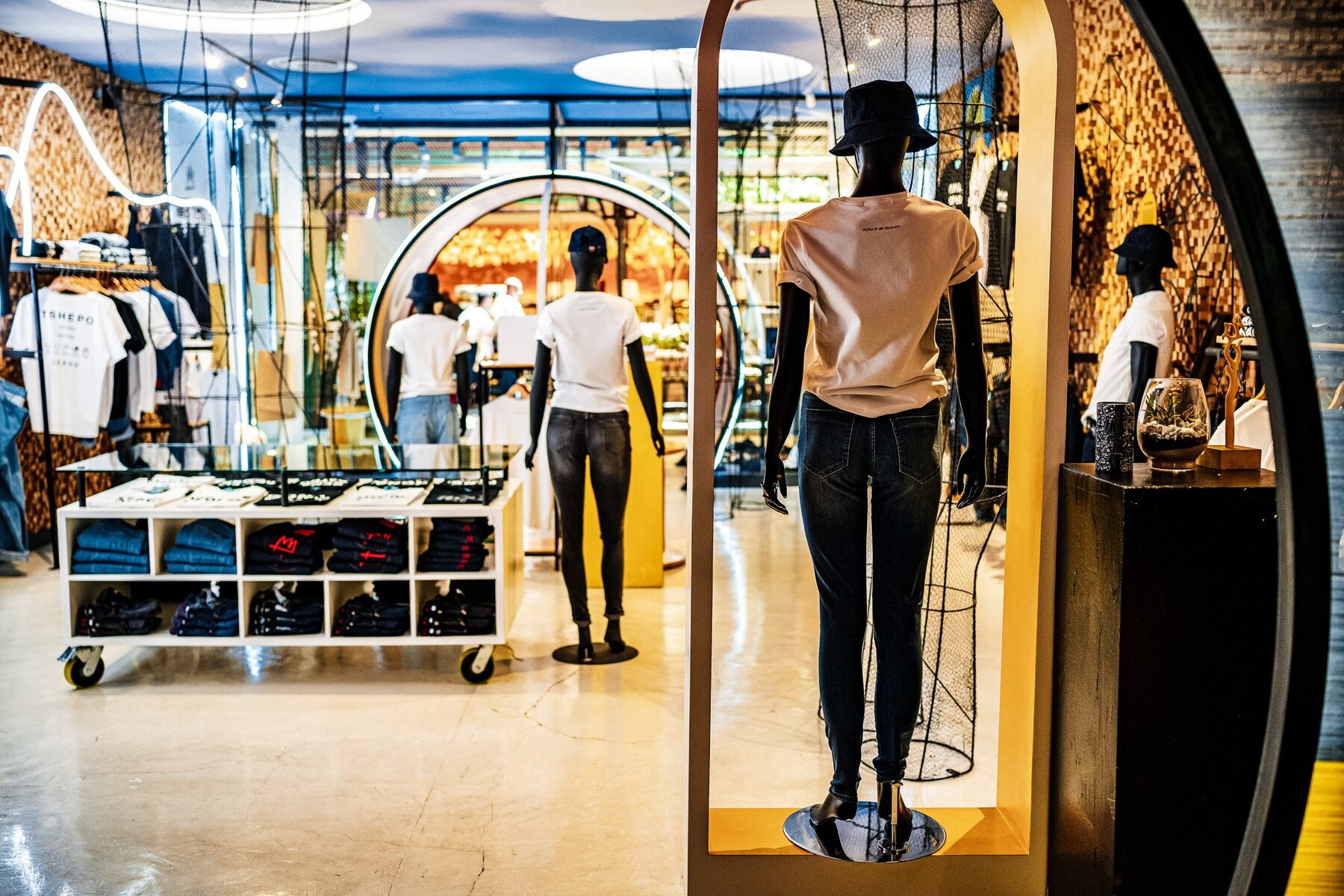 Black mannequins presenting denim in a Tshepo Jeans retail interior